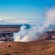 A smoking crater in a barren landscape